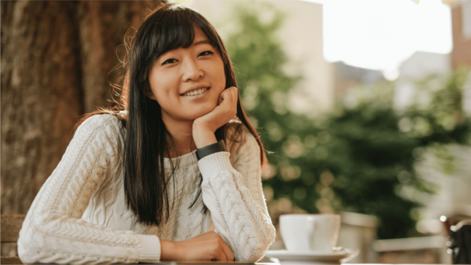 Asian Woman Smiling at camera with hand on chin