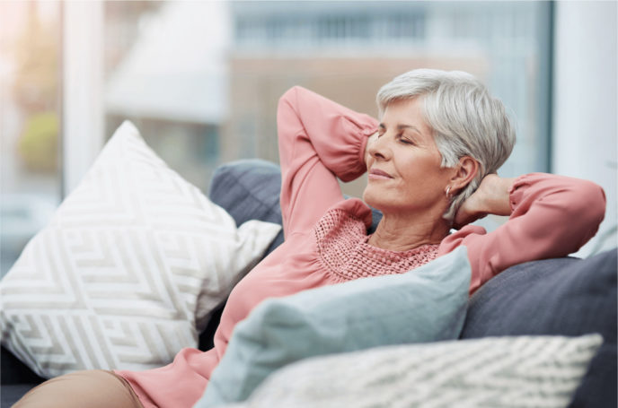 Older Woman on couch with hand behind her head