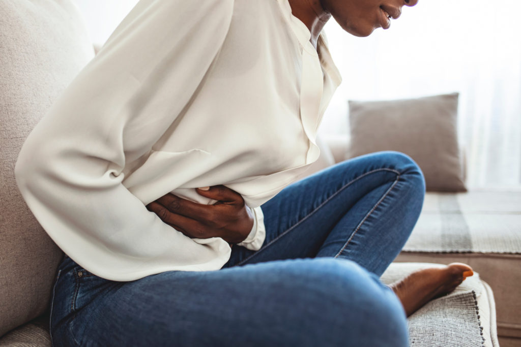 Woman Stomach Pain on Couch